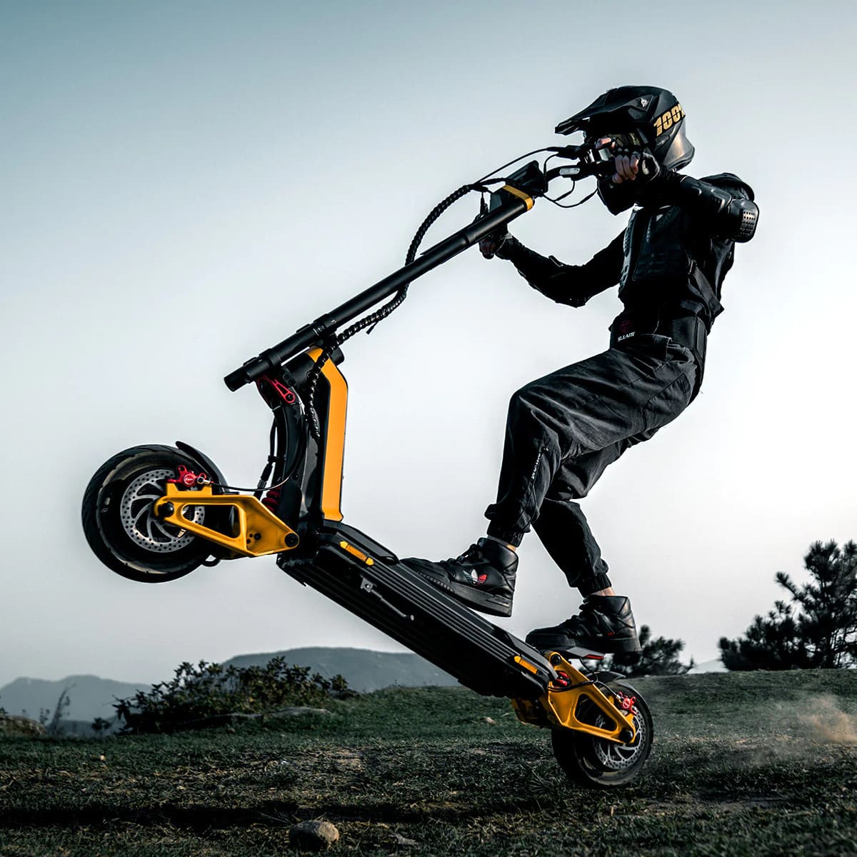 A rider performing an off-road stunt on a high-performance electric scooter in a rugged outdoor setting.