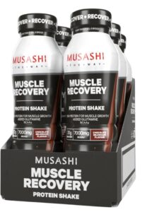Musashi Muscle Recovery Protein Shake bottles in a 6-pack display box, Chocolate Milkshake flavor.