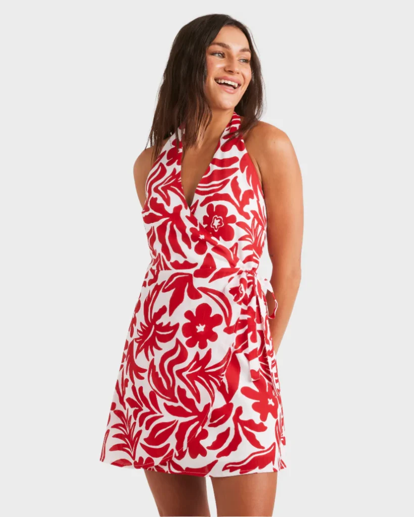 Roxy women's dress featuring a bold red and white floral pattern, wrap-style design, and halter neckline. Perfect for summer outings and beach days. Shop now at www.waiteandsea.com.au.