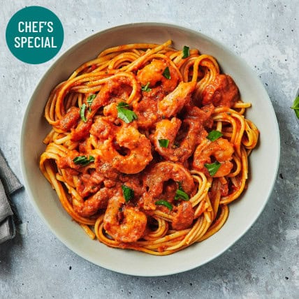 Prawn Linguine with Creamy Tomato and Basil Sauce: A Chef's Special meal supporting your health and fitness journey.