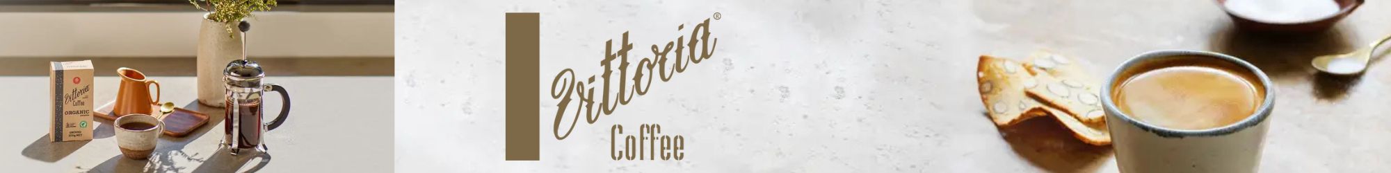 Vittoria Coffee banner featuring a cup of freshly brewed coffee, French press, and organic coffee packaging. Experience the rich flavour of premium espresso blends and organic ground coffee. Shop now at www.waiteandsea.com.au.